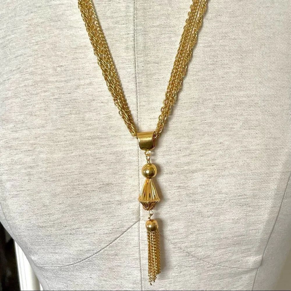 Gold tone multi chain tassel necklace